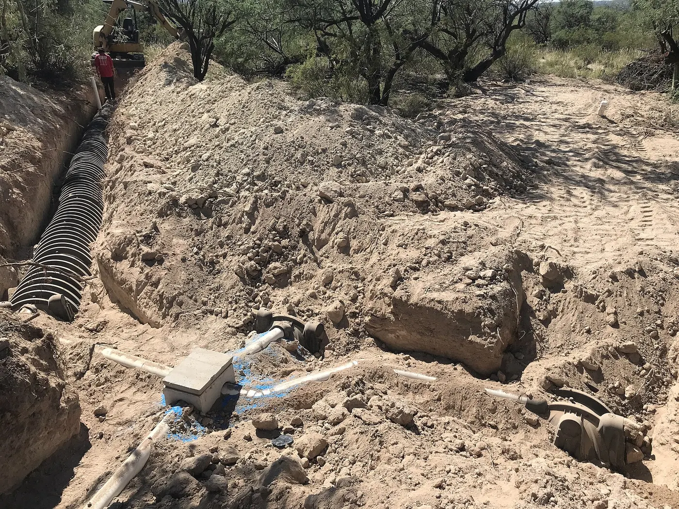 Drain field trench with chamber pipe being installed